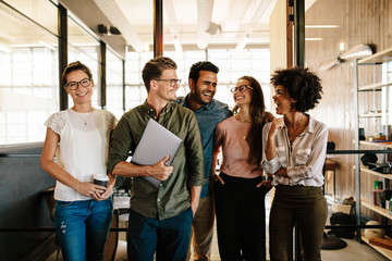 Successful business team standing together and smiling