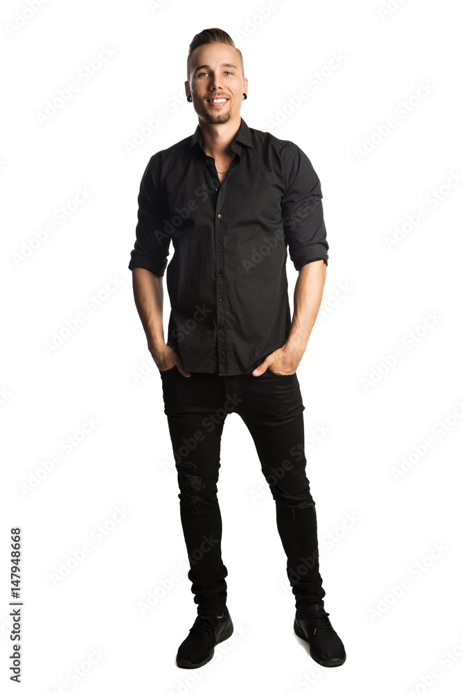Handsome man in black shirt and black jeans, standing against a white background feeling great and comfortable with a smile. Handsome man in black shirt and black jeans, standing against a white background feeling great and comfortable with a smile.