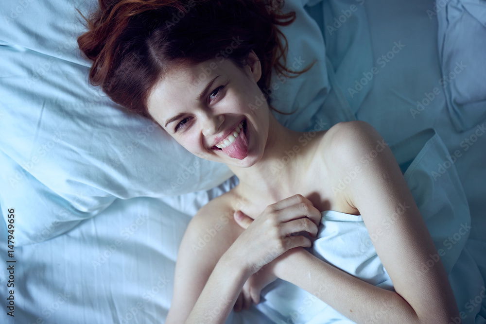 happy woman in bed, morning awakening - obrazy, fototapety, plakaty 