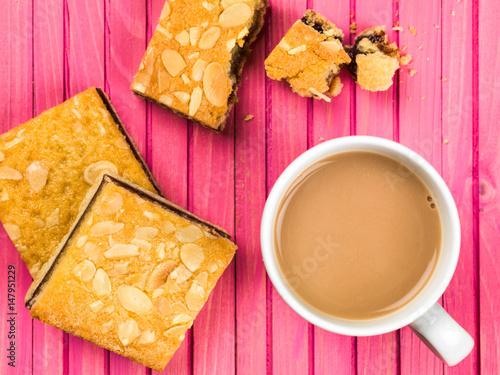 Cherry Bakewell Tarts With a Cup or Mug of Tea or Coffee photo