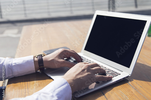 Businessman at work. Close-up top view of man typing on laptop