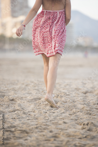Beautiful girl in a sexy dress on the beach