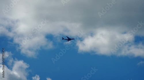 Plane Flies Across Blue Sky photo