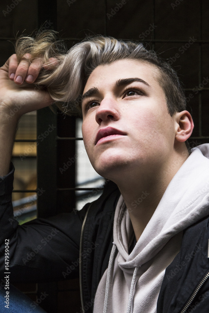 Portrait of daydreaming young man with dyed hair looking up Portrait of daydreaming young man with dyed hair looking up