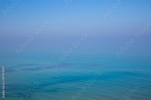 Sea and sky without horizon at sunrise. Background with the ocean view.