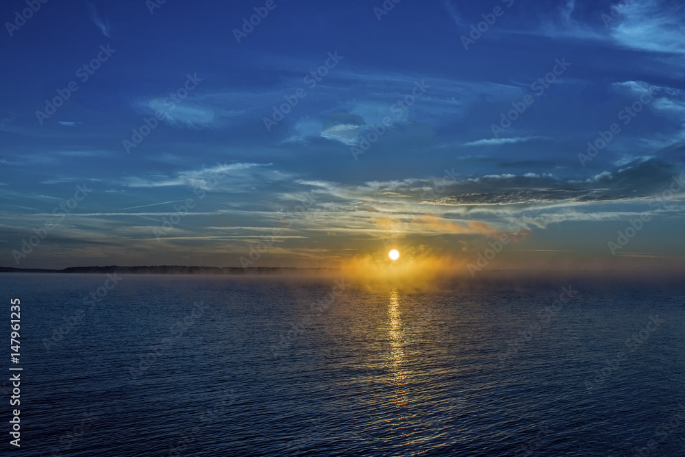 Misty sunrise, sunset on a body of water Misty sunrise, sunset on a body of water