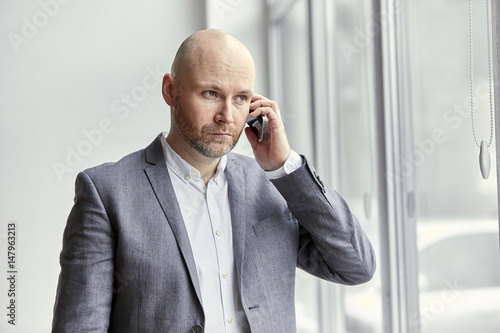 Bald Businessman Having an Important Phone Call