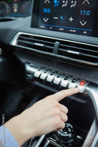 Closeup photo of young woman pressing emergency button in car © ZoomTeam