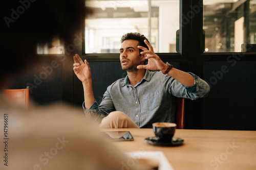 Man explaining business strategy to colleagues in conference roo
