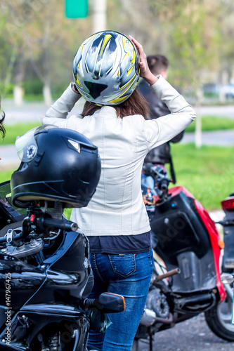 Girl in motorcycle helmet on motorcycle - Girl biker in a leather jacket