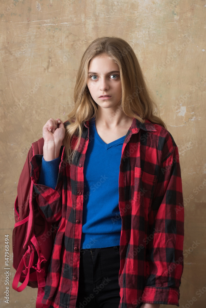 beautiful young girl in red checkered shirt with backpack beautiful young girl in red checkered shirt with backpack