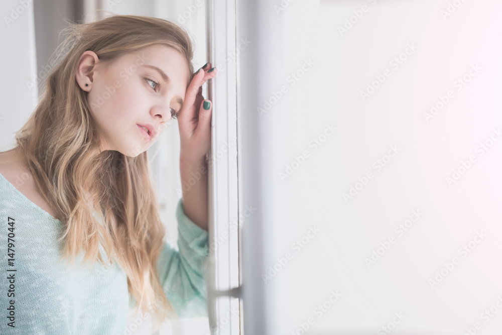 Pretty girl looking out of window Pretty girl looking out of window
