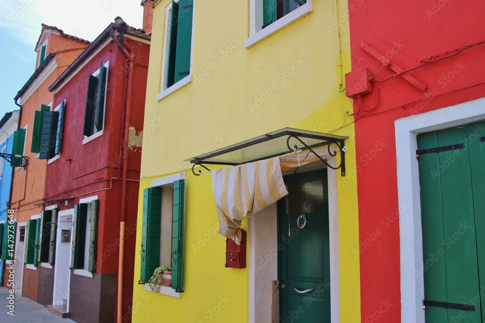 Bright colored houses on the island Burano, situated in the Lagoon of Venice, Italy, Europe.