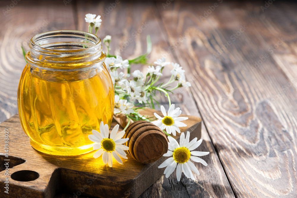 jar with fresh flower honey and dark wooden background jar with fresh flower honey and dark wooden background