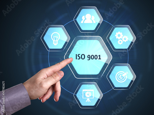 Business, Technology, Internet and network concept. Young businessman shows the word: ISO 9001