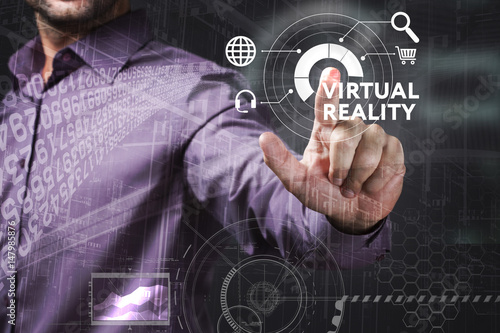 Business, Technology, Internet and network concept. Young businessman working on a virtual screen of the future and sees the inscription: Virtual reality