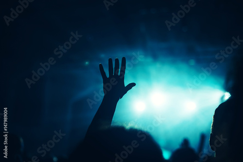 Fototapeta Naklejka Na Ścianę i Meble -  Female hand raised in the air on rock music concert