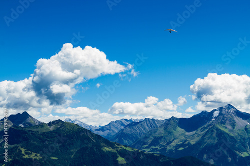 High mountains landscape with hang glider in soaring flight. Austria, Tirol, Zillertal