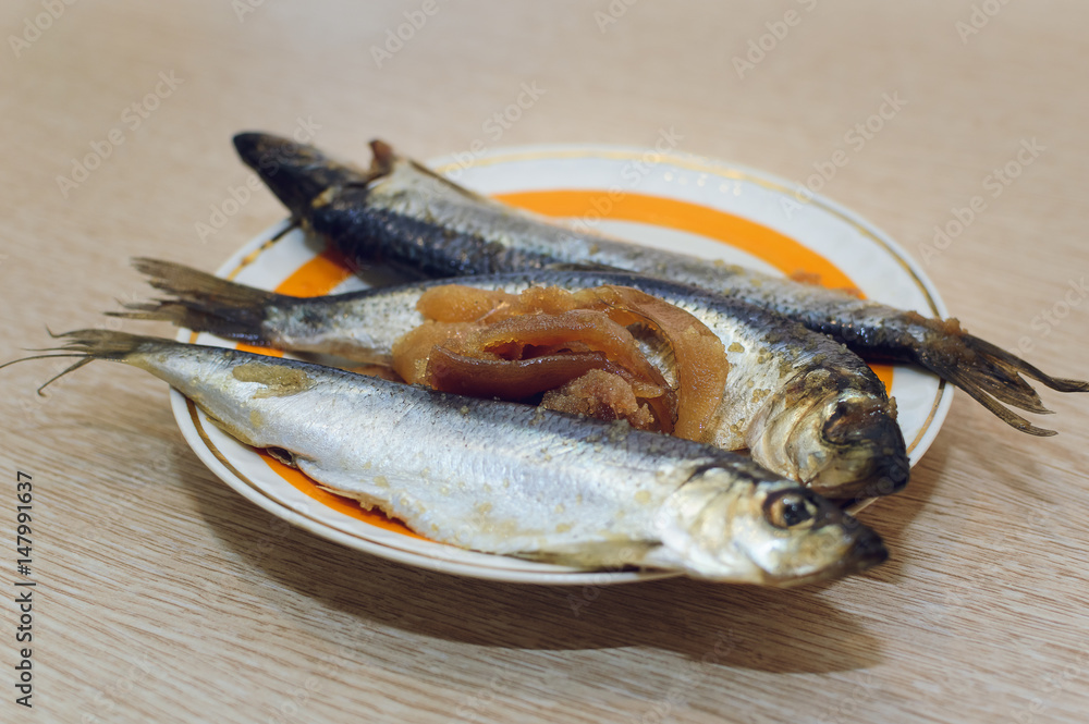Salted fish Clupea harengus membrane with caviar lies on a plate. Close-up, selective focus.