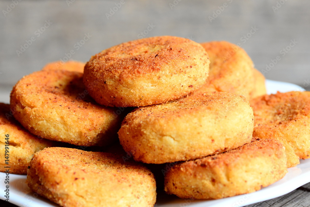 Spicy chickpea cutlets on a plate. Roasted cutlets cooked with chickpeas puree. Simple, tasty and hearty recipe idea. Rustic stile. Closeup Spicy chickpea cutlets on a plate. Roasted cutlets cooked with chickpeas puree. Simple, tasty and hearty recipe idea. Rustic stile. Closeup