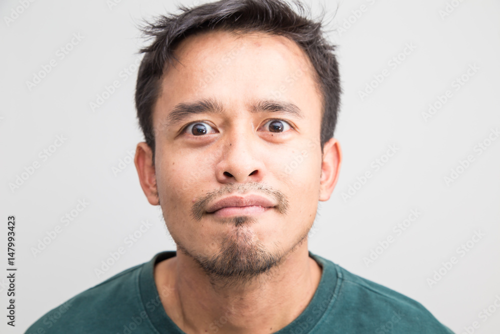 Obraz premium Crazy frown asian man on white background, Upset feeling