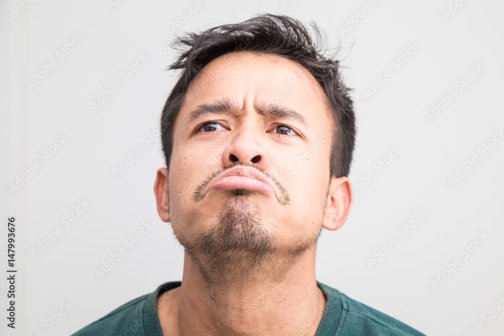 Obraz premium Crazy frown asian man on white background, Upset feeling