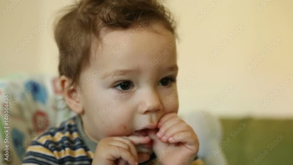 Cute baby boy put his hands into mouth and looks absorbed
Cute baby boy put his hands into mouth and looks absorbed