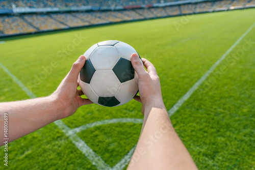 person holding soccer ball on soccer field stadium © LIGHTFIELD STUDIOS