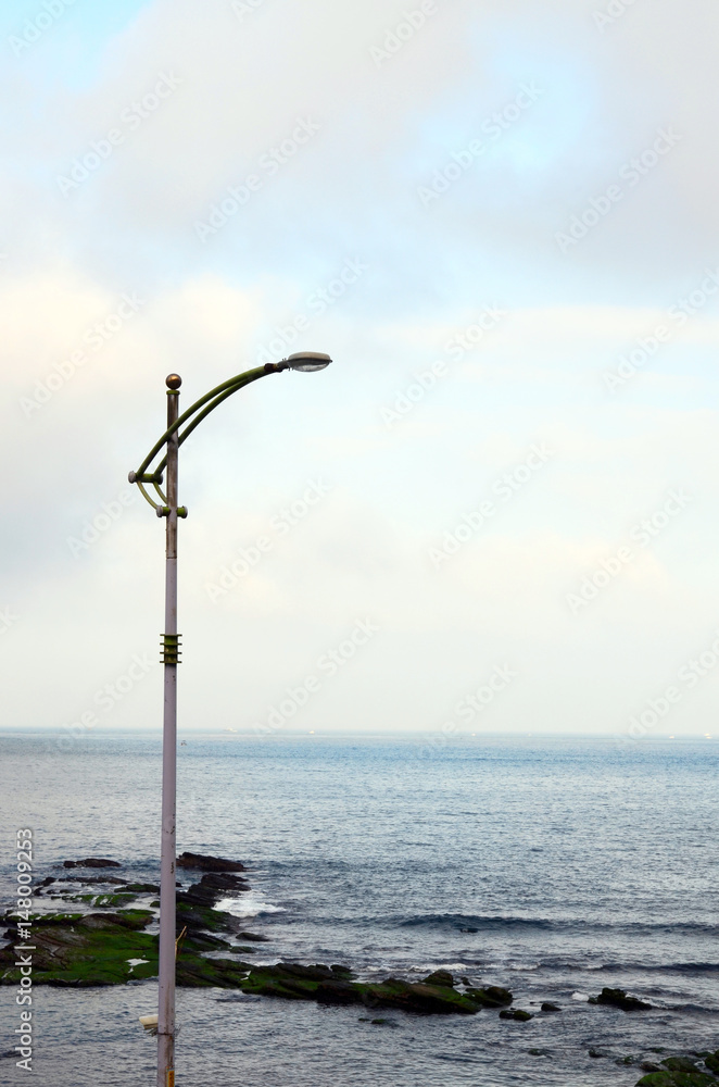 Street lamp stood beside the seashore