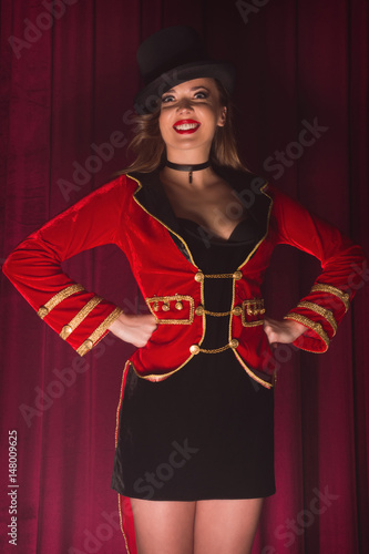 Beautiful woman trainer in a circus suit