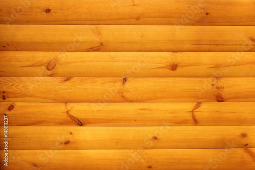 Orange wooden slats with knots joined together. Wooden texture background