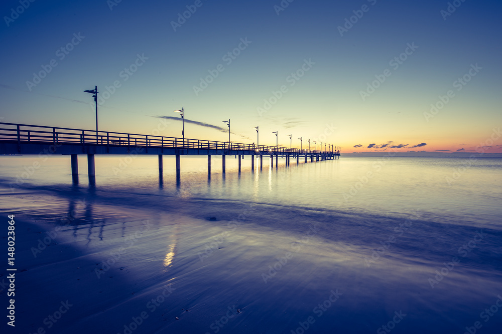 Wooden pier in Mechelinki. Small fishing village in Poland. Amazing Sunrise at the beach