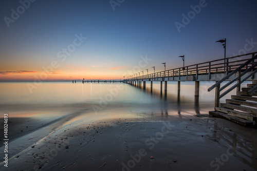 Wooden pier in Mechelinki. Small fishing village in Poland. Amazing Sunrise at the beach