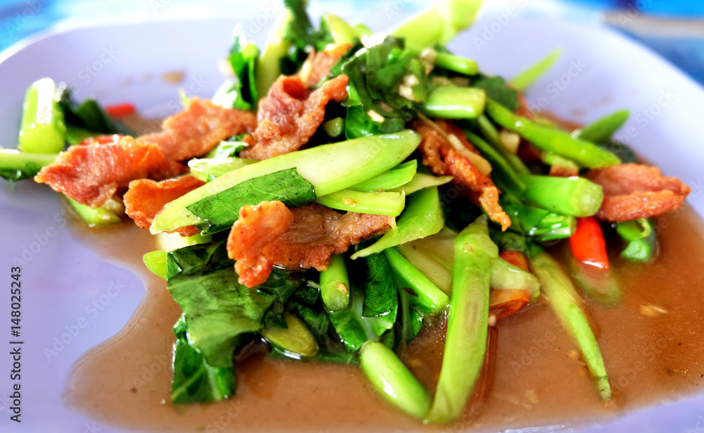 Close up stir-fried kale with crispy pork and oyster sauce,Thai cuisine. Close up stir-fried kale with crispy pork and oyster sauce,Thai cuisine.