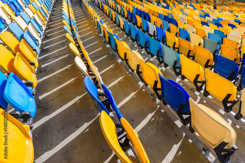 rows of yellow and blue stadium seats on soccer stadium