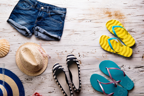 Summer vacation composition. Denim shorts, hats and flip flops.