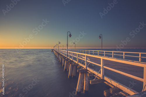 Fototapeta Naklejka Na Ścianę i Meble -  Amazing sunrise on the pier at the seaside. Gdynia Orlowo, Poland