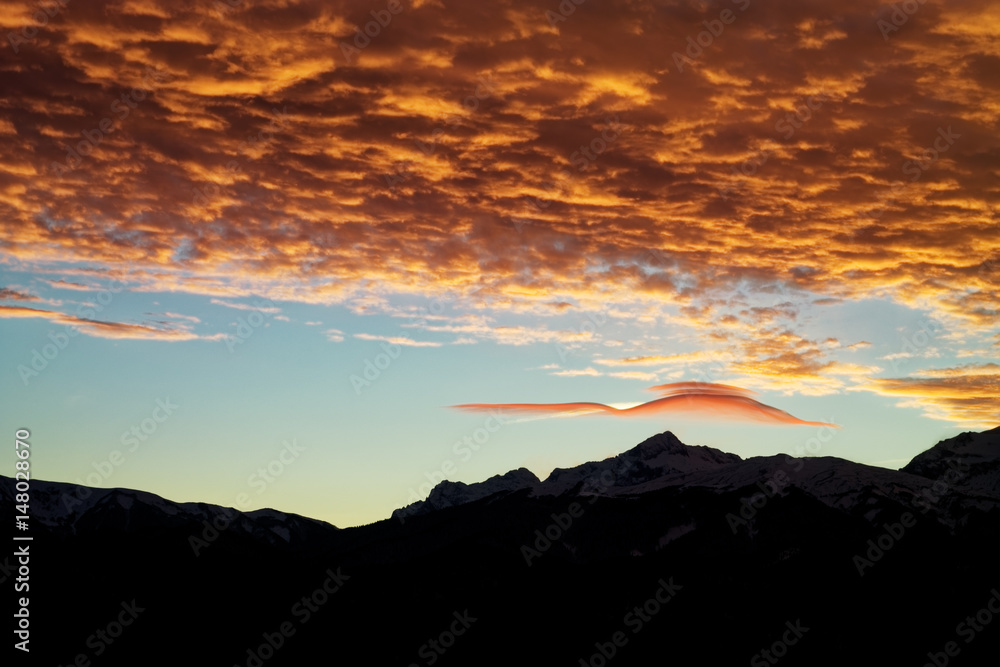 Lenticular (lens-shaped) clouds after sunset. Caucasus. Russia. The Caucasian reserve. Plateau of Lagonaki Lenticular (lens-shaped) clouds after sunset. Caucasus. Russia. The Caucasian reserve. Plateau of Lagonaki