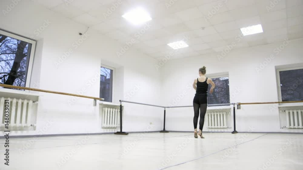 graceful girl practicing ballet in the Studio, slow motion , does pirouettes graceful girl practicing ballet in the Studio, slow motion , does pirouettes