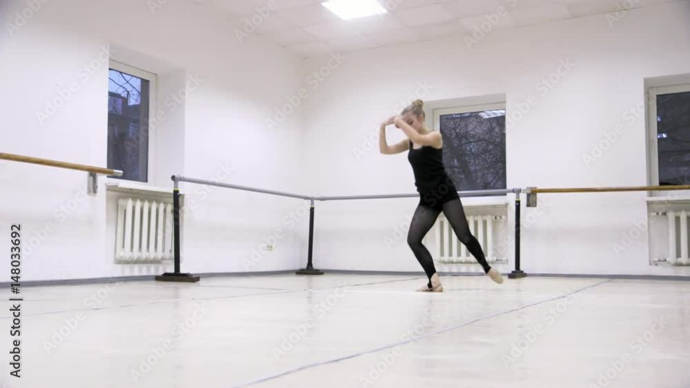 graceful girl practicing ballet in the Studio, slow motion , does pirouettes graceful girl practicing ballet in the Studio, slow motion , does pirouettes