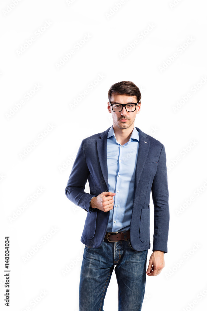 Fototapeta premium Handsome young man in blue jacket. Studio shot, isolated.