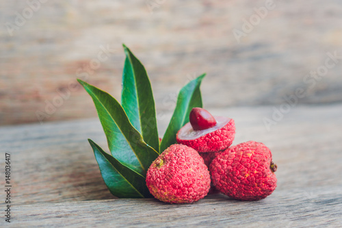 Fresh litchi fruit on an old wooden background photo