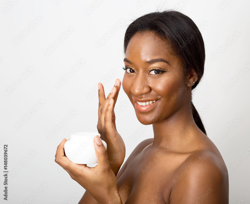 african american beauty using face cream