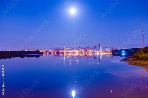 Reflection of the night city on the water surface. © Sergej Ljashenko