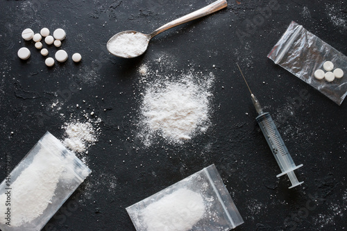 Canvastavla Set of different drugs - powder and pills and a syringe on a black background
