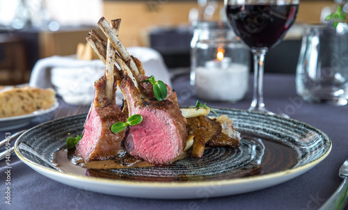 Roasted lamb chops with chanterelles and vegetables on decorated table