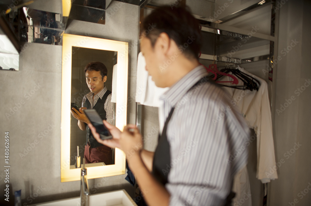 Asian man is busy getting ready for party. Asian man is busy getting ready for party.