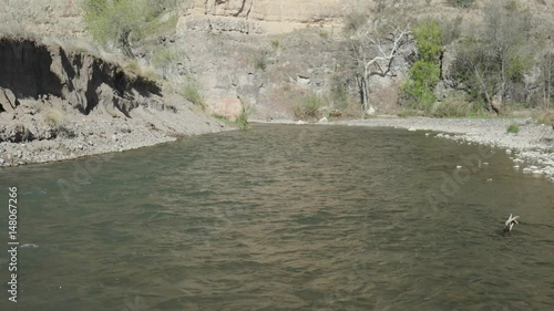 Static shot of river flowing and big cliff in the background photo