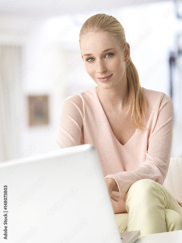 Home office. Shot of a young woman using her laptop at home. Home office. Shot of a young woman using her laptop at home.