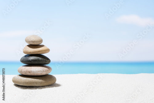 Relaxing in the tropical beach  with white sand and stack of stones